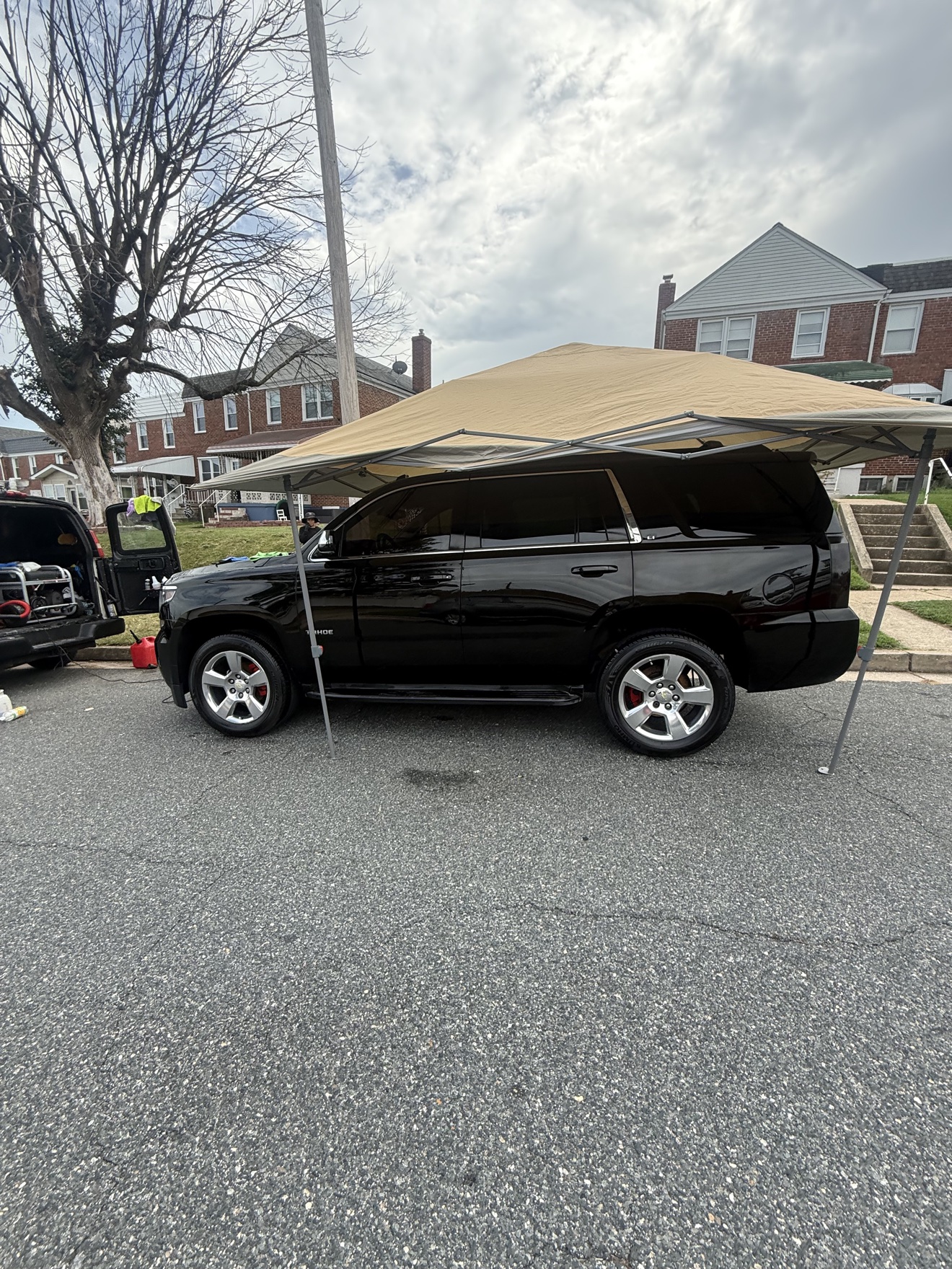 Chevy Tahoe after full detail — deep gloss black paint